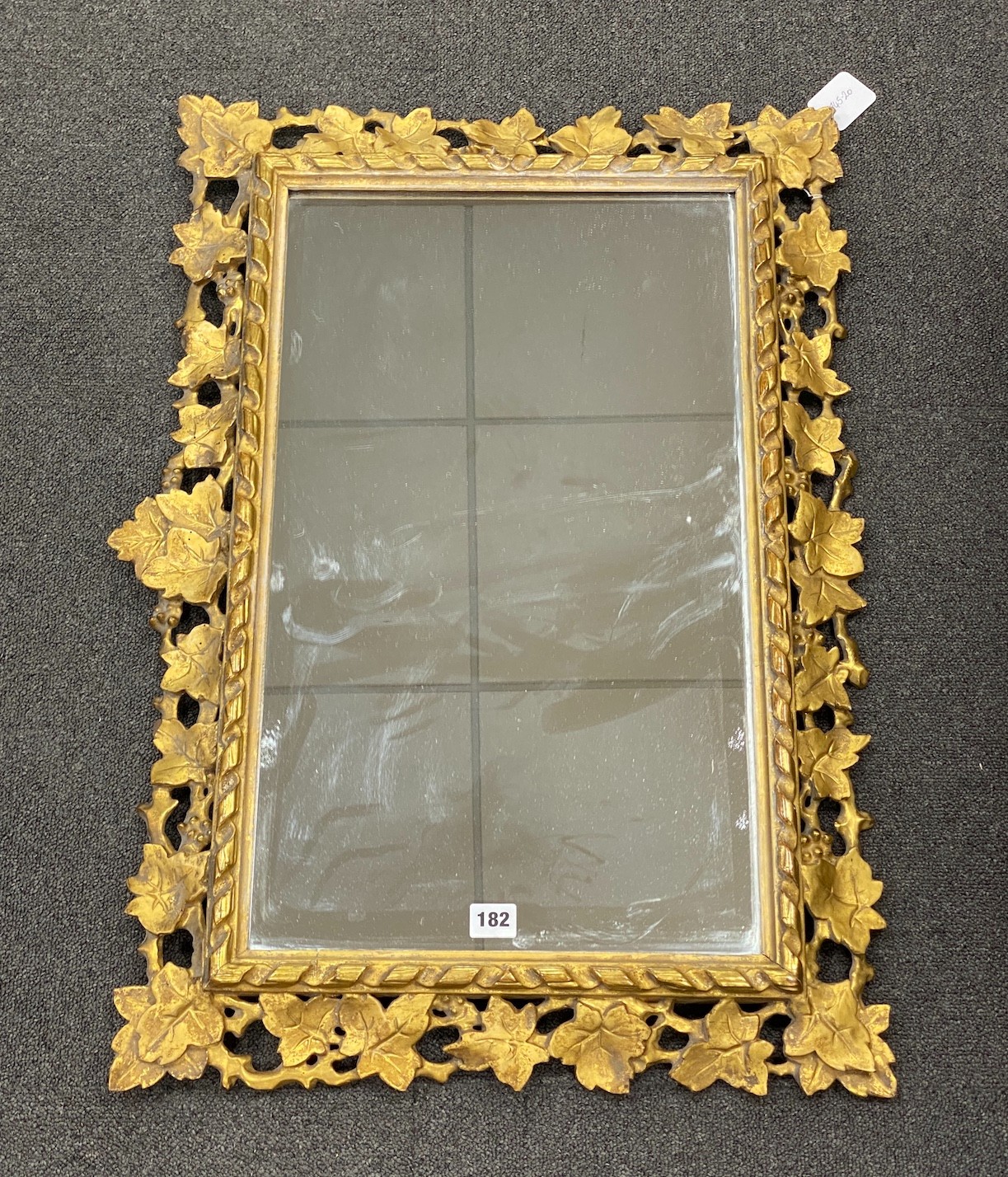 A giltwood carved giltwood wall mirror with ivy leaf border, width 52cm, height 76cm